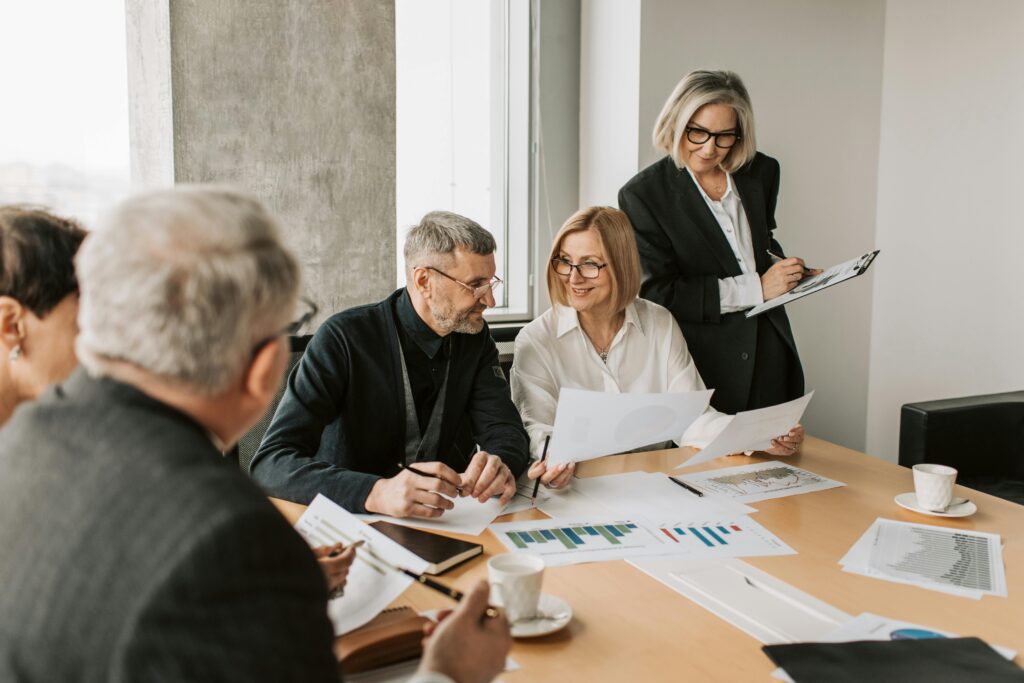 pexels photo 7433822 7433822 A diverse group of business professionals engaged in a strategic meeting.